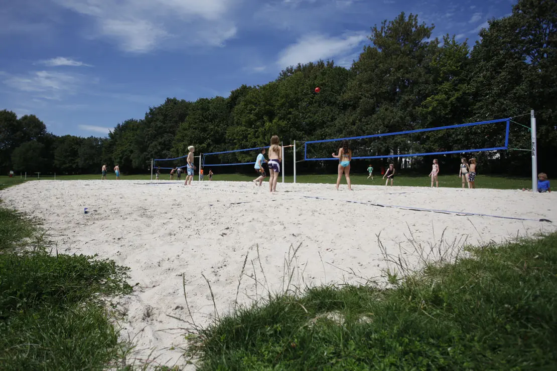 Beachvolleyball-Platz mit spielenden Jugendlichen im Freibad Rosental.